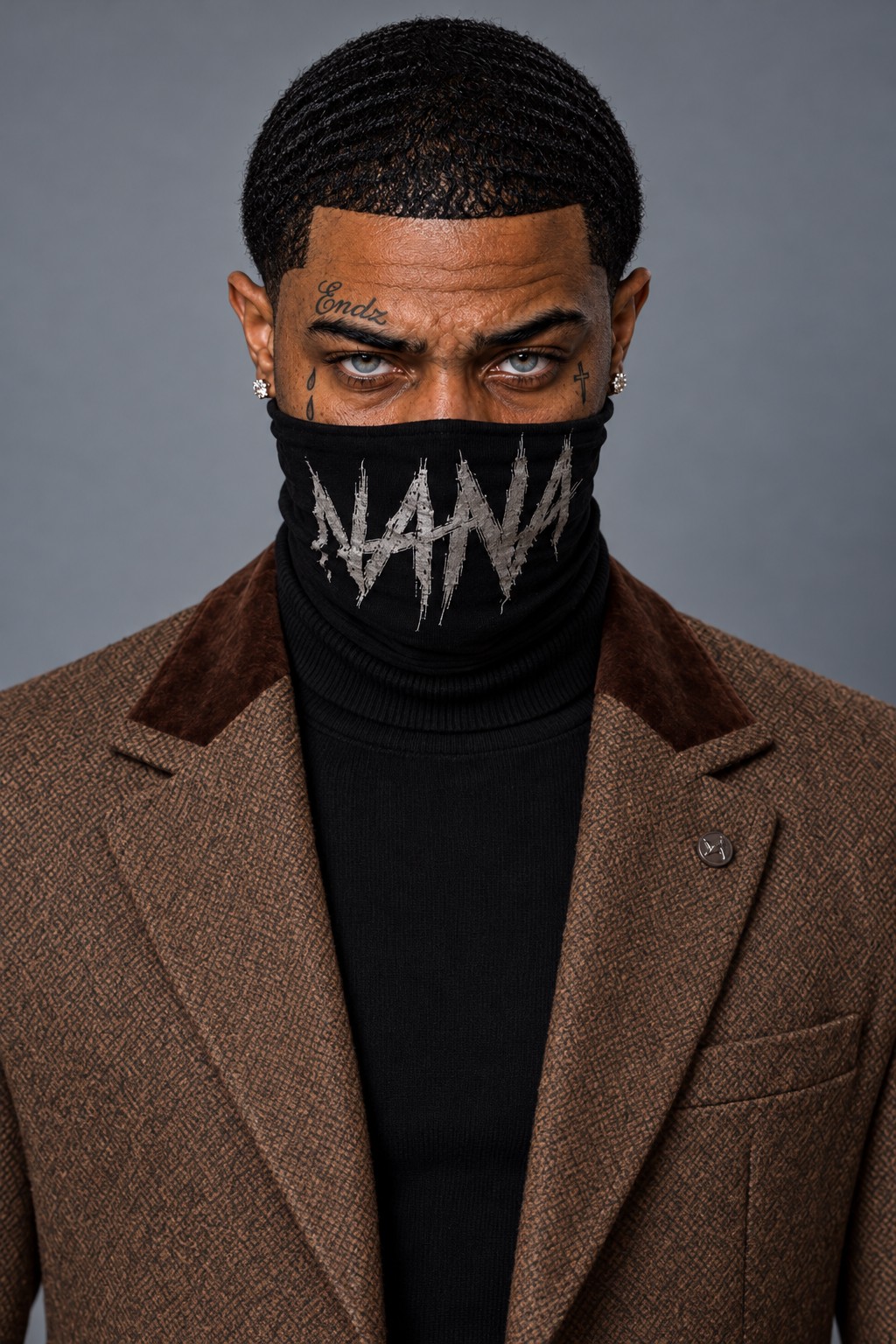 Nana Endz in a brown textured jacket and black turtleneck, wearing his signature face covering